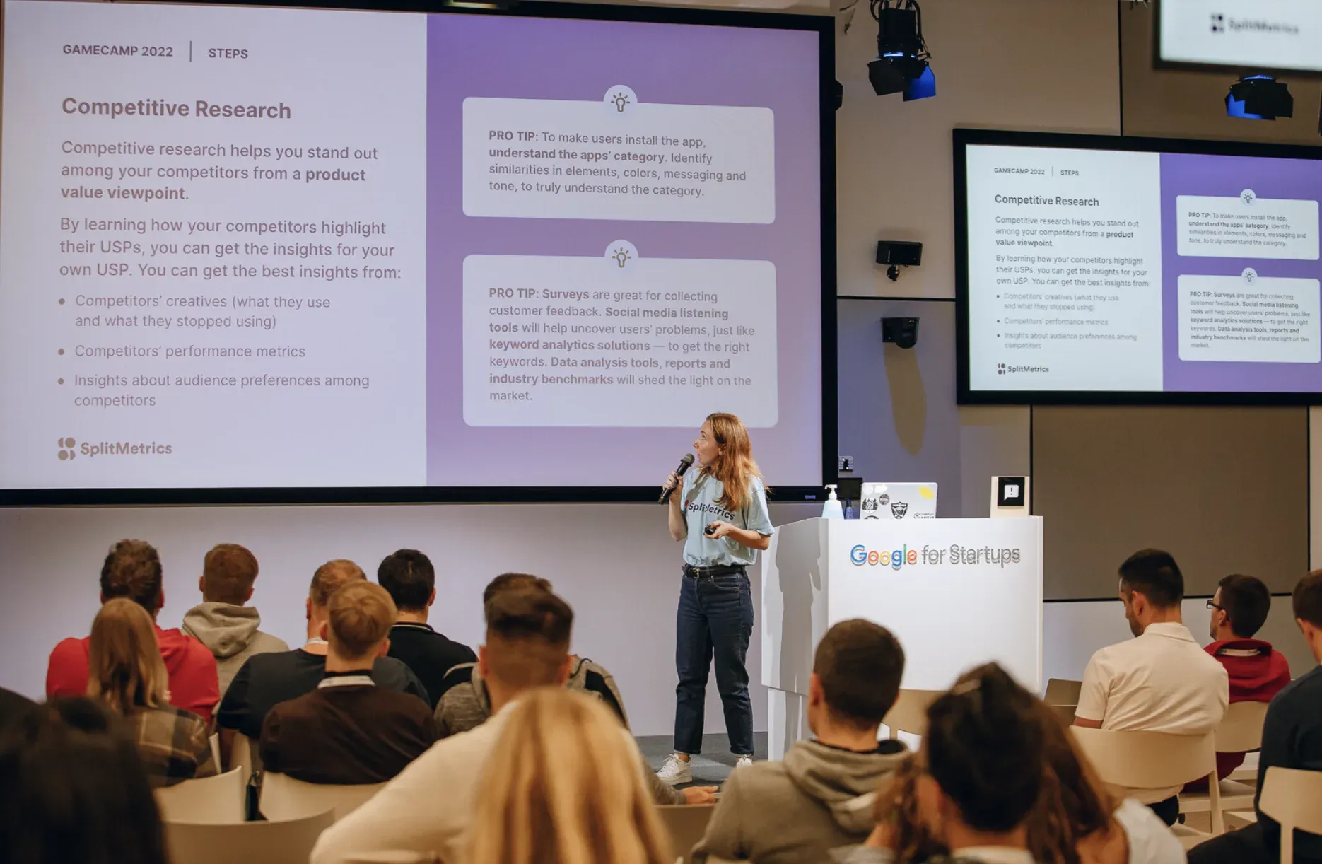Nadia Nazarova on the main stage at Gamecamp, presenting a Competitive Research slide beside a Google for Startups lectern